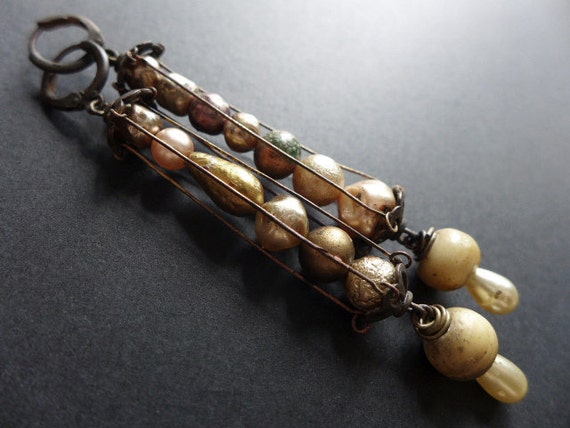 Bone Moons. Caged baroque pearl earrings.