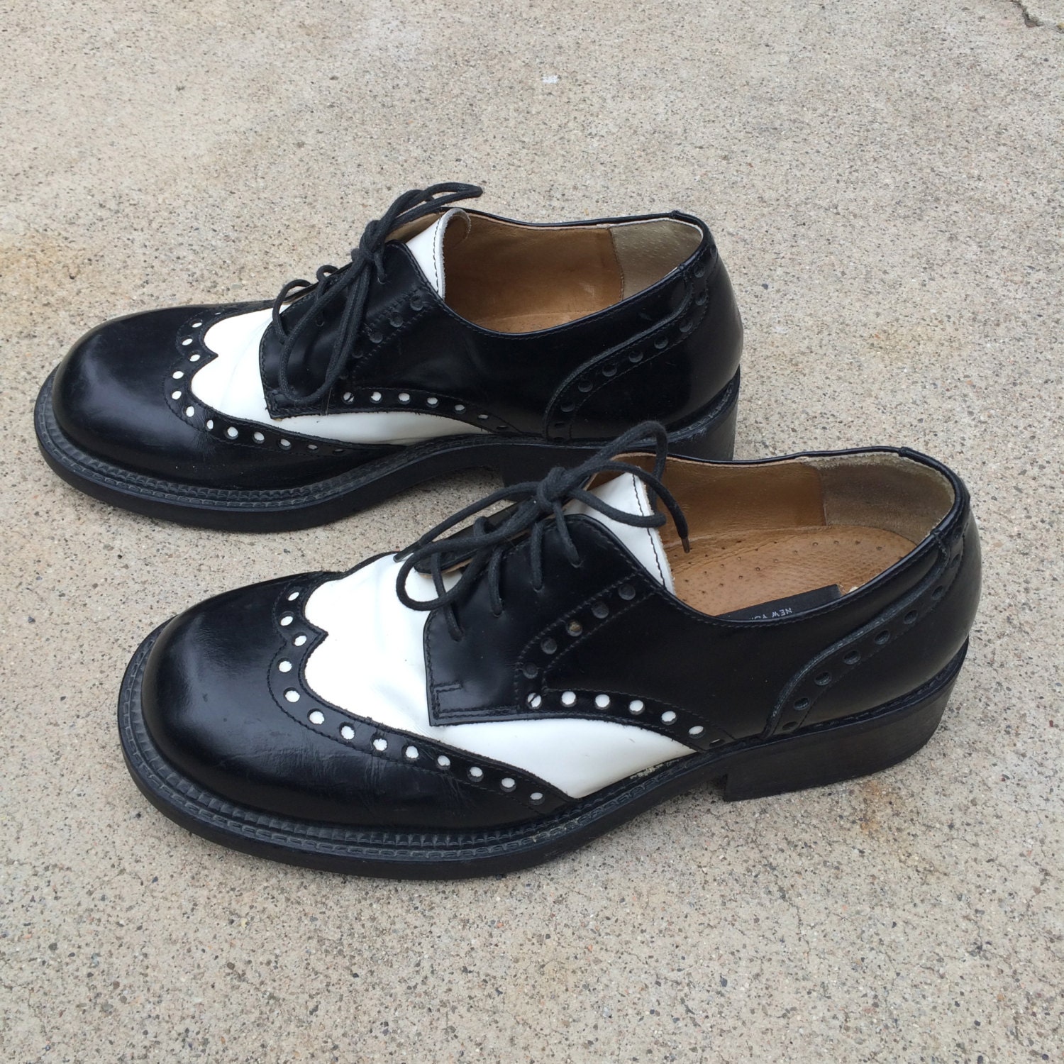 black and white spectator flats