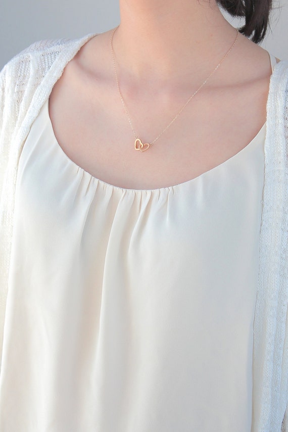 Gold interlocking hearts necklace (model photo)