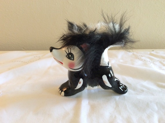 ceramic skunk figurines