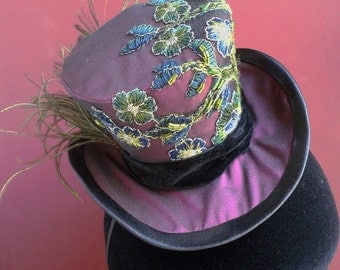 Purple mini top hat with hand-sewn embroidered tulle applique and peacock feather