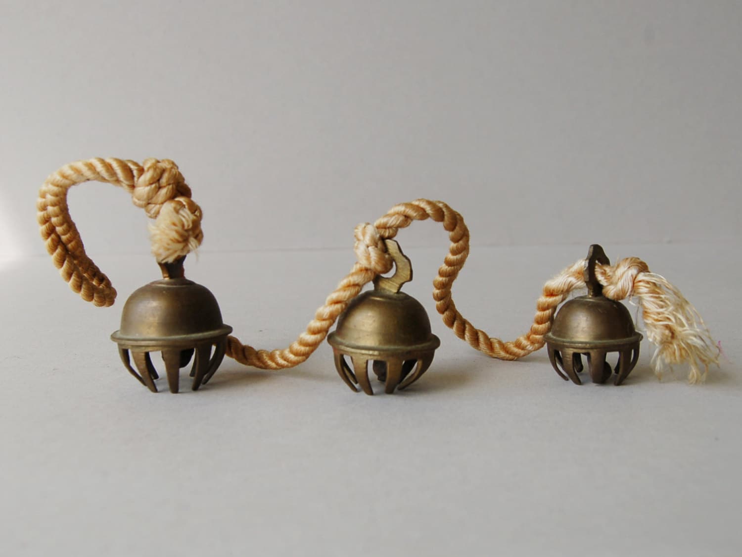 Antique brass elephant bells Set of 3 claw bells on cord Brass