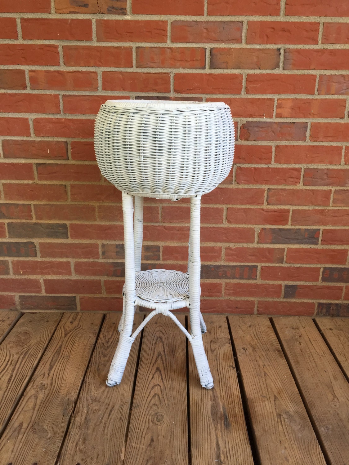 white wicker plant stand