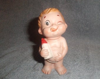 vintage porcelain baby figurine with bottle