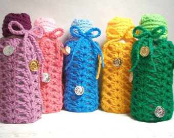 Bottle Banks are making a change. Upcycled plastic bottle banks handmade with crocheted tops.