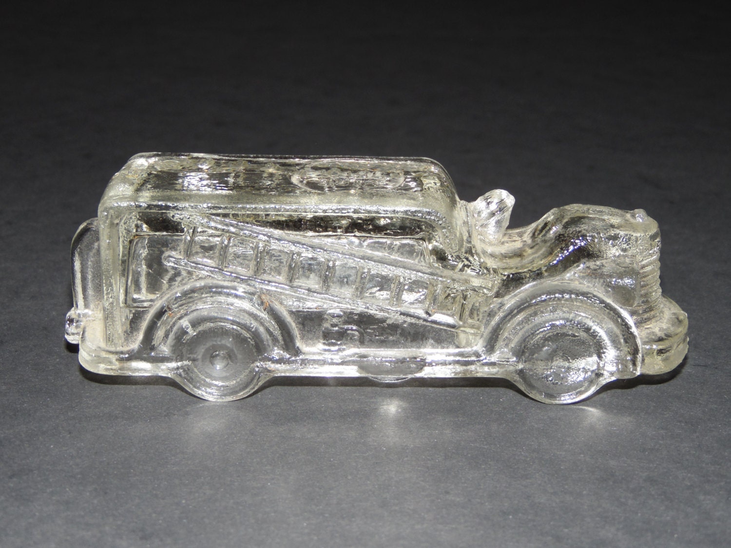 vintage clear glass fire truck candy container marked FIRE