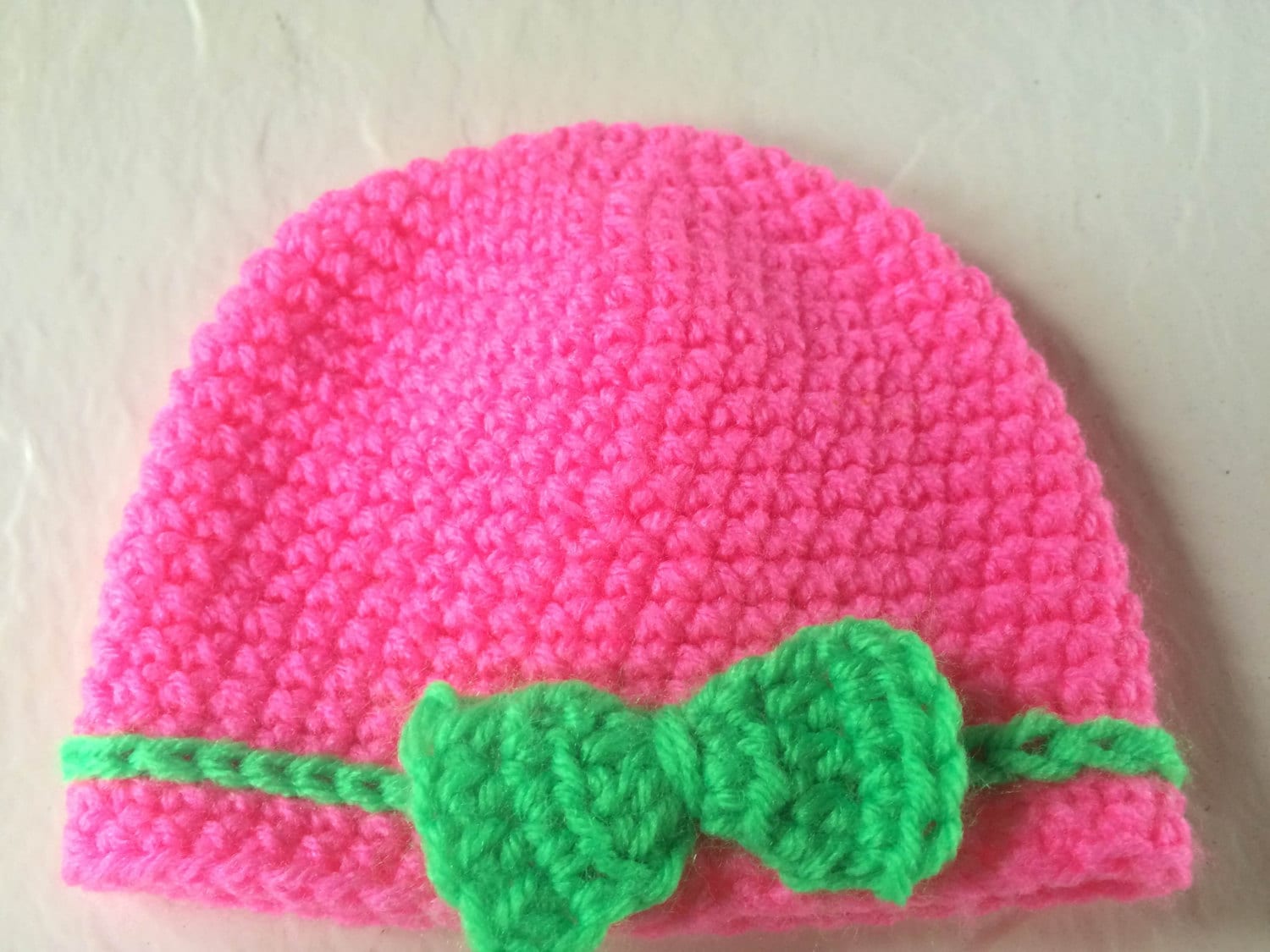 Crocheted baby hat with bow