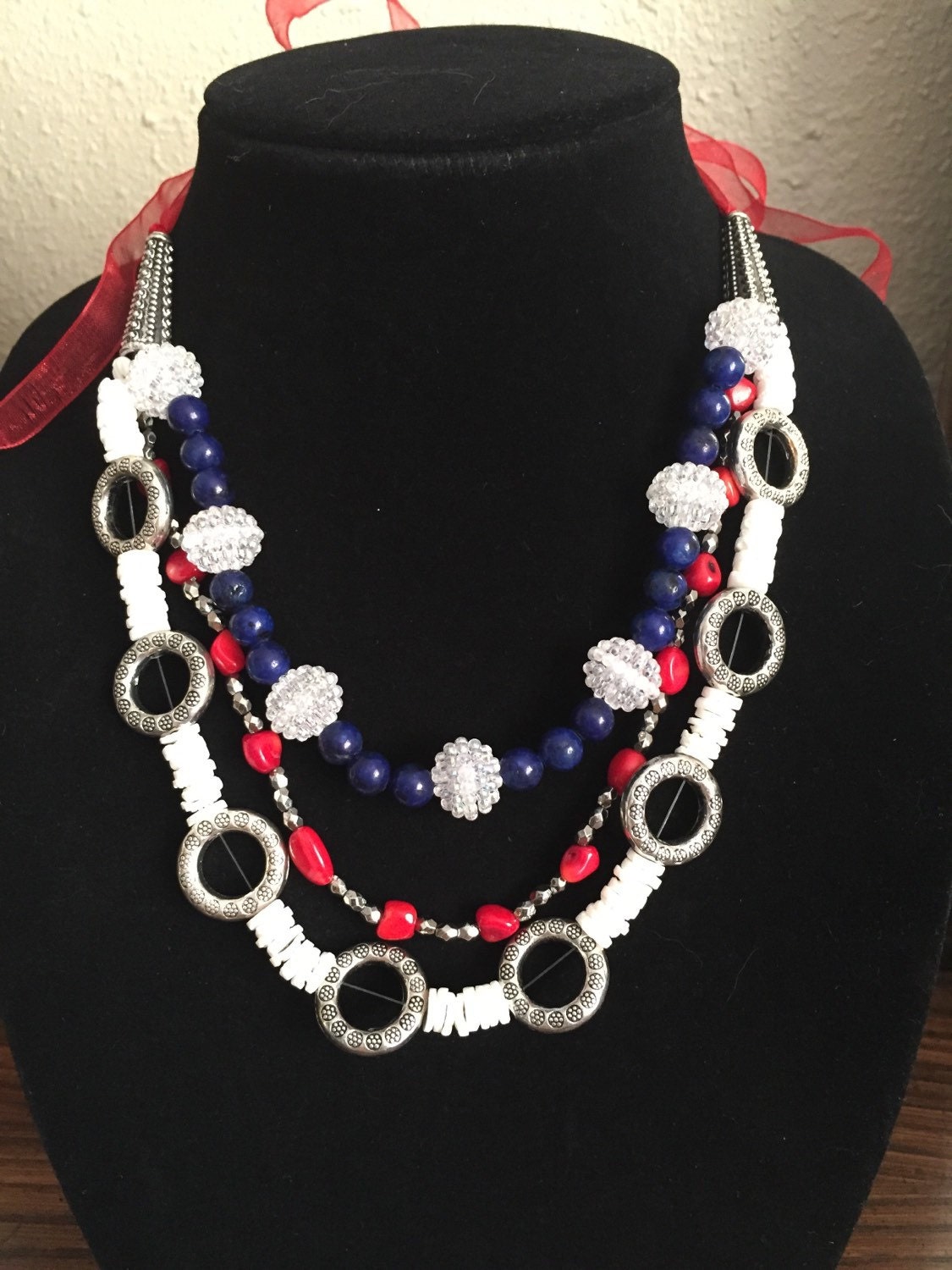 Red white and blue bead necklace on ribbon