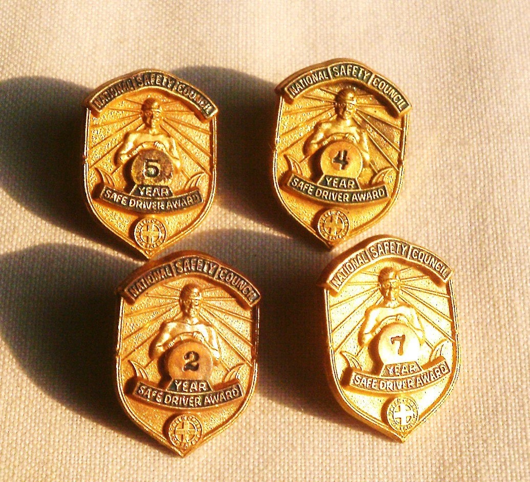 Four Gold National Safety Award Pins