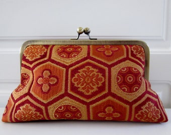 orange and gold clutch bag