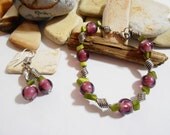 Purple and green bracelet and earrings. Purple glass bracelet with green mother of pearl chips. Purple bracelet with matching earrings.