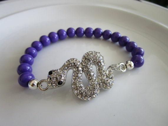 Silver tone clear bejeweled snake charm elastic bracelet with