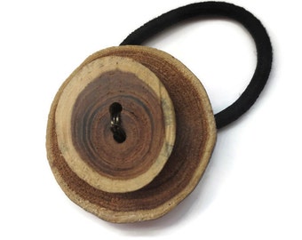 Elastic band for hair in wood puck