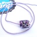 Flamework glass bead jewellery supply handcrafted with white base and purple glass frit comes with free lilac cord