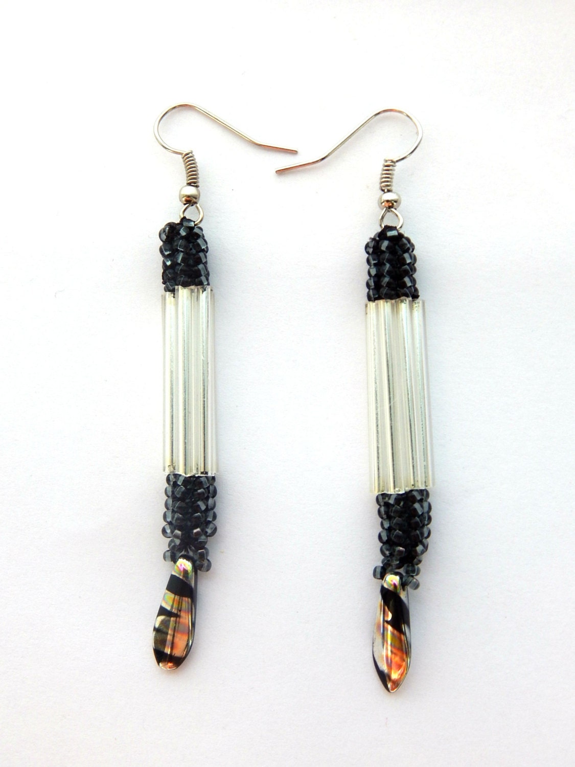 White dangle earings with black sparkly beaded dangling ear