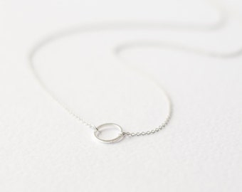 Geometric silver necklace with karma circle pendant
