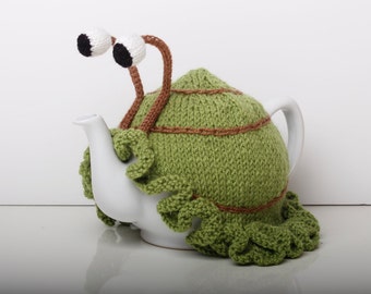 Knitted green snail tea cosy with frilly bottom. Washable fits 1 litre teapot. Available with or without teapot.