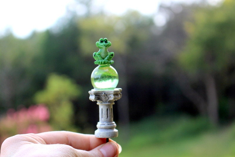 Frogs gazing ball towerGreen ball on pedestalOh how I love