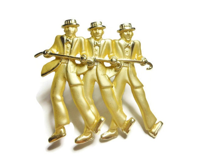 Dancing Men Brooch, skimmer hats and top coats or tails, vaudeville dancers in matte gold finish with glossy highlights, including canes