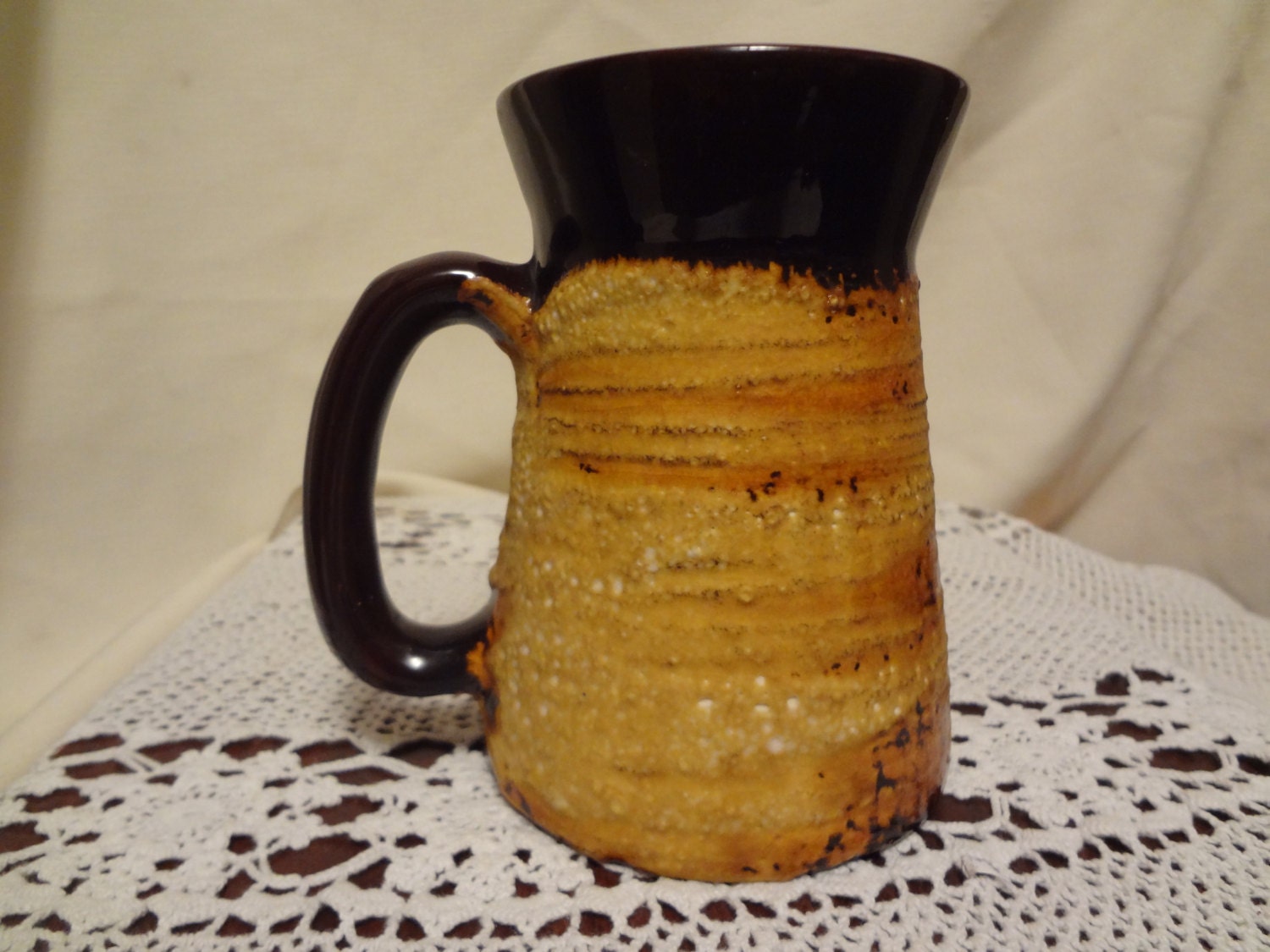 Brown glazed mug, yellow hard outer lava glaze Laurentian Pottery