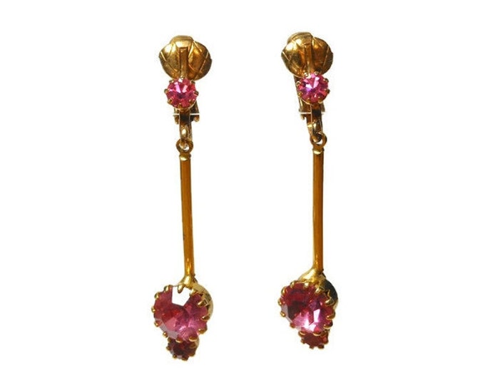 Pink rhinestone earrings, gold clip dangle earrings, prong set rhinestone on ear then a swinging bar with two more rhinestones at bottom