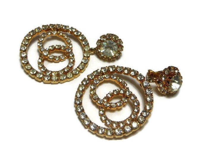 Circle rhinestone earrings, infinity knots inside a circle dangle from a large rhinestone circled by smaller ones, prong set clip earrings