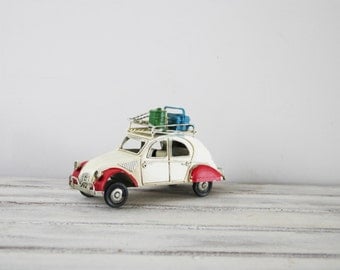 Deux Chevaux car miniature, vintage French white 2CV Citroen collectible miniature with red fenders and baggage on the rack, mid nineties