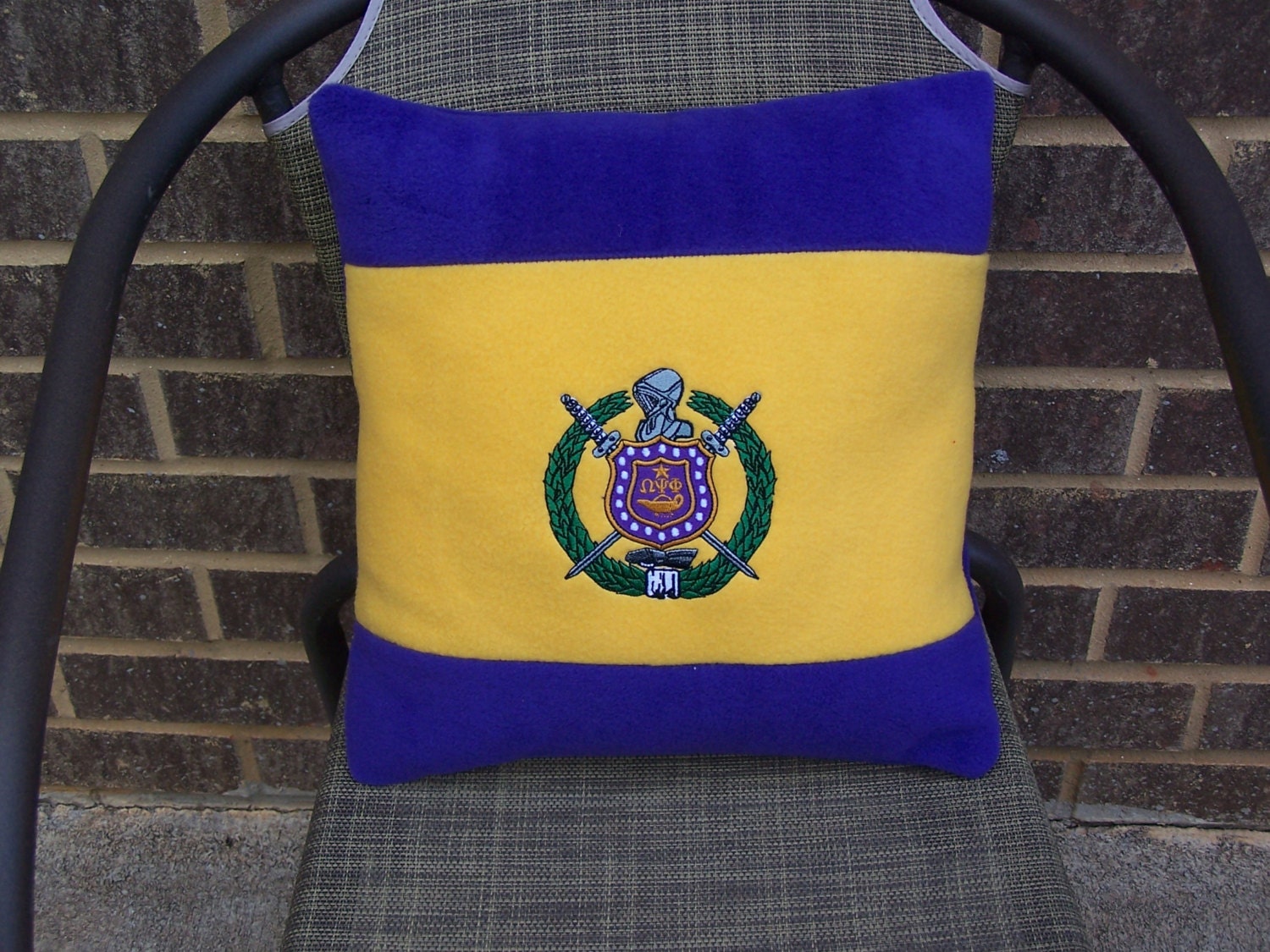 Omega psi phi embroidered shield on purple  gold color Omega psi phi embroidered shield on purple  gold color