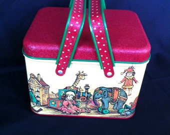 A Decorative Tin With Handles And Toy Design By Potpourri Press Made In USA