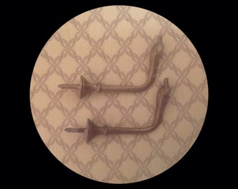 Two Gold Coloured vintage French, Curtain Tie Back Hooks. Cast Bronze. Flame decoration see Photo 2. Screws for attachment to the wall.