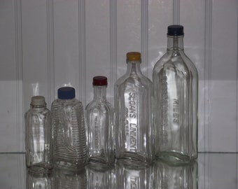 From the 40's and 50's, a collection of vintage glass bottles, all with freshly primed & painted metal caps.
