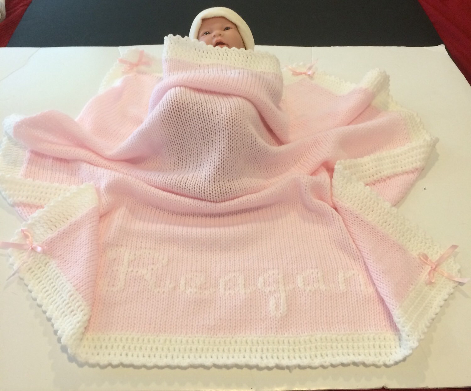 Handmade Knitted baby blanket with crocheted edging.
