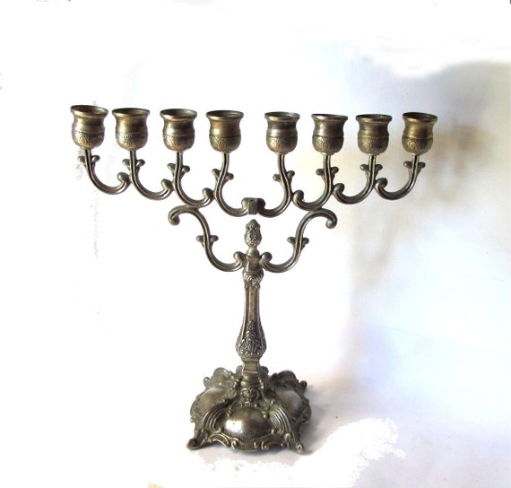 Tall ornate silver plated candelabra. Hanukkah menorah. Jewish