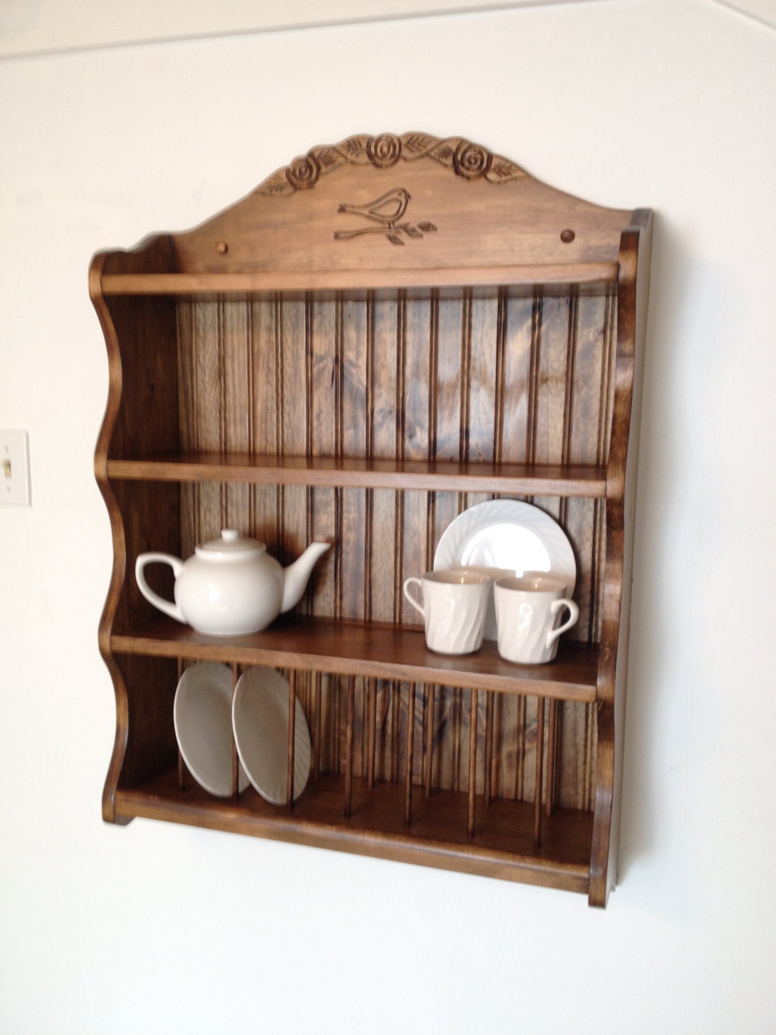 Tea set collection shelf.