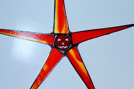 Skinny Jackie- 9 inch stained glass star with striated glass and jack-o-lantern center