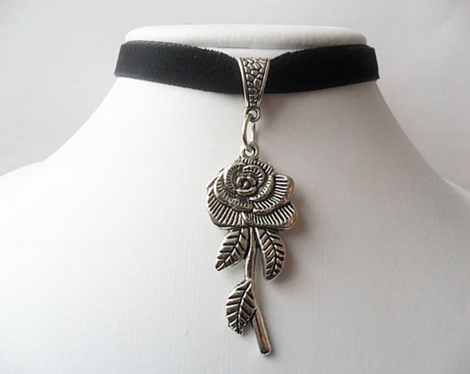 Black velvet choker necklace with a rose flower pendant and a width of 3/8” inch.