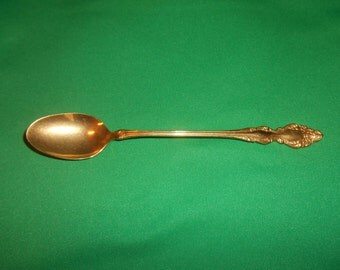 One (1), 7 3/8" Gold Electroplated, Iced Tea Spoon, from Oneida in the Golden Baroque Rose Pattern.