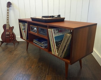 Mid century modern stereo/turntable console or record player cabinet featuring sapele mahogany with tapered wood legs.
