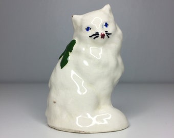 small vintage ceramic cat figurine with blue bow