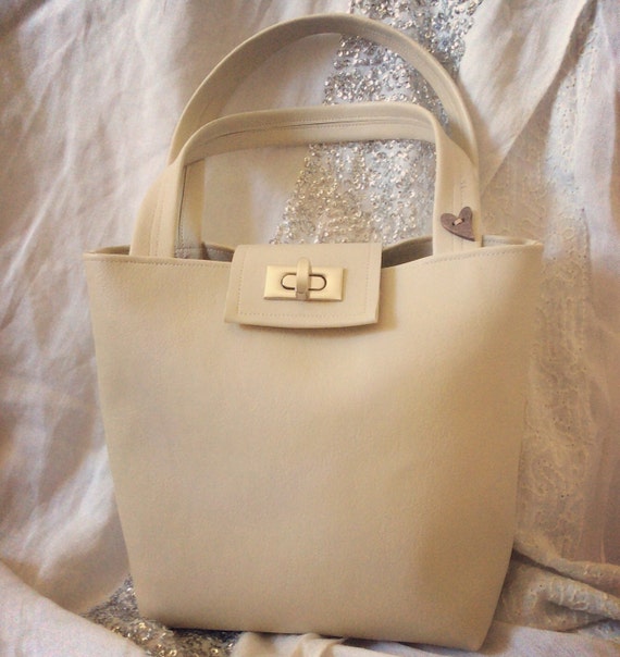 cream over shoulder bag