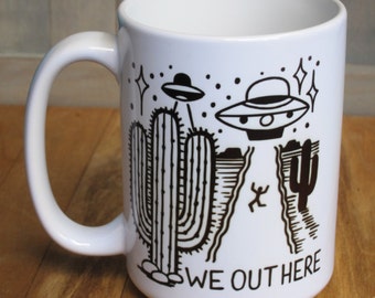 UFO "We Out Here" coffee mug | 15 ounce ceramic coffee cup with original ufo alien desert design