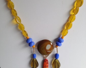 Necklace in shades of yellows, oranges and lilacs.