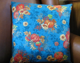 16"x16" Gorgeous teal fall pillow cover is stunning, a background in rich teal, with vivid bursts of orange pumpkins and sunflowers.