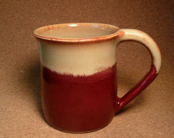 Stoneware mug in deep red, creamy tan