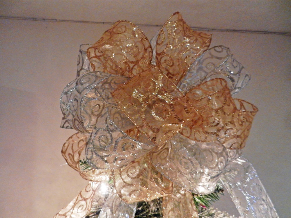 large christmas tree topper bow made with a sheer gold ribbon large christmas tree topper bow made with a sheer gold ribbon