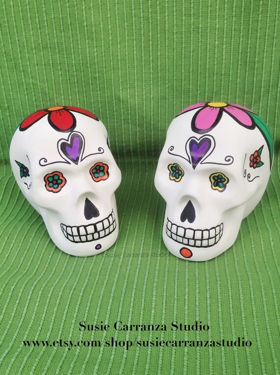 Ceramic Skulls set of 2. Hand painted by Susie Carranza.