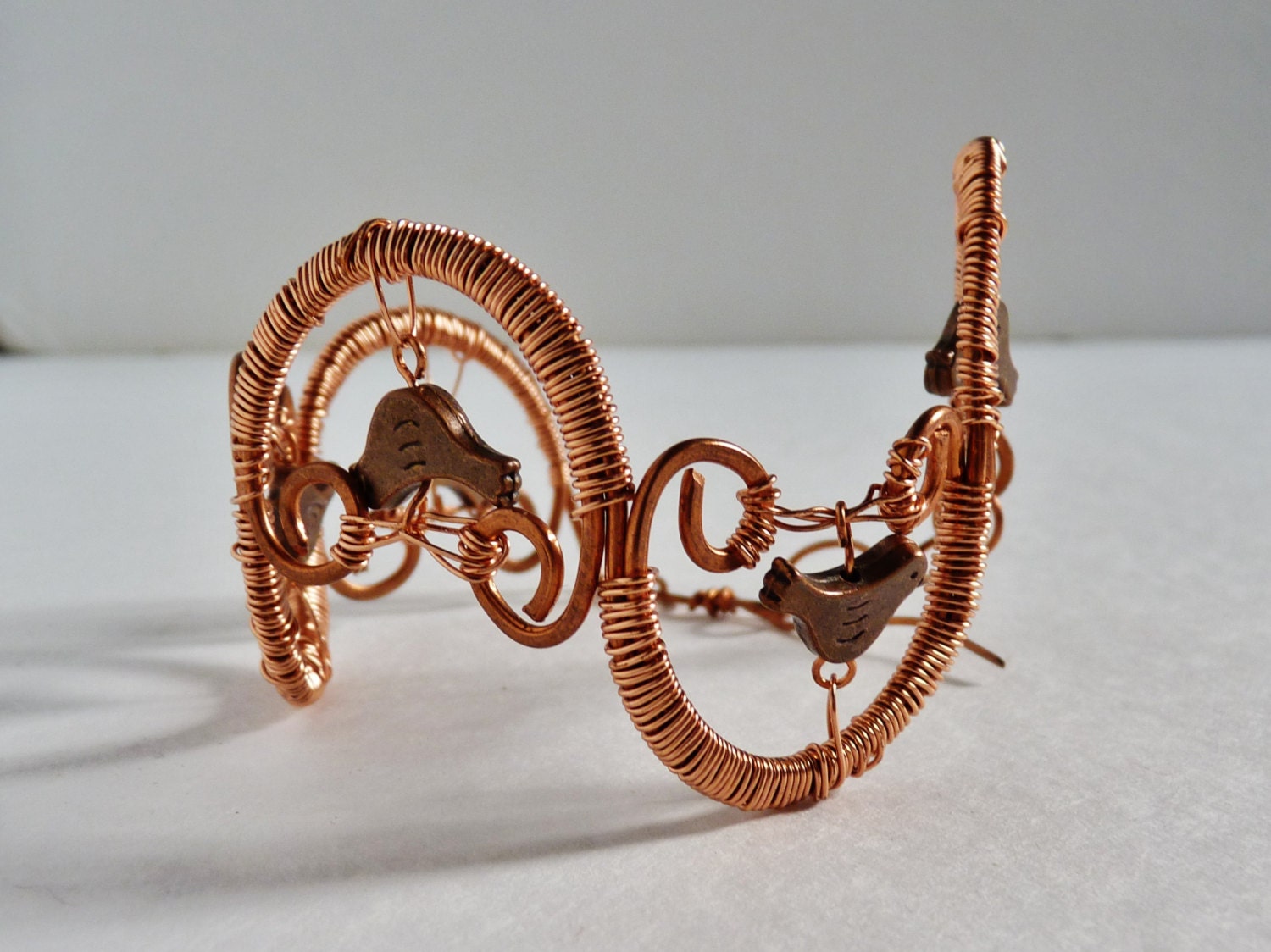 Solid copper wire and little copper birds in a handmade