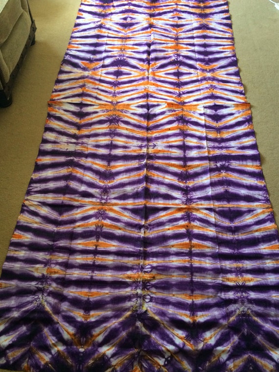 Orange purple and white cotton Batik fabric from Uganda.