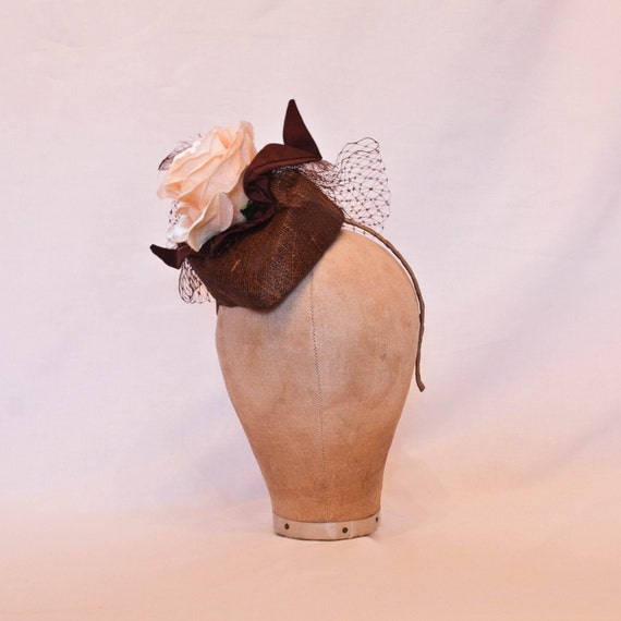 Coffee brown hat decorated with a peach rose and tulle