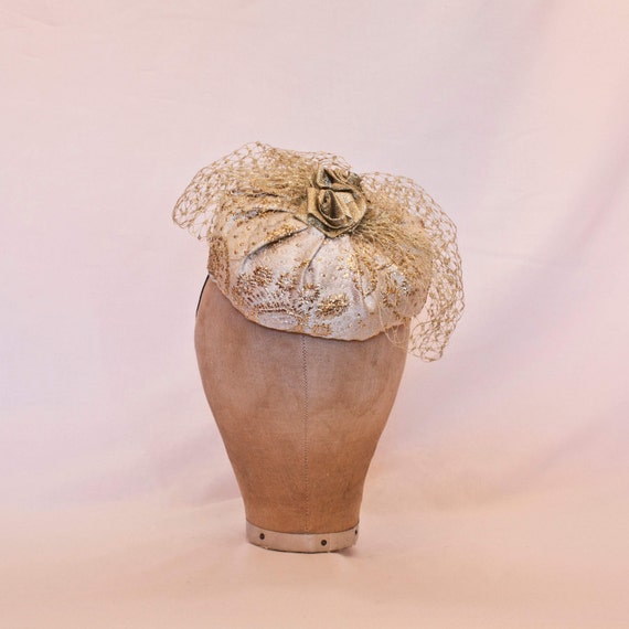 Cute gold brocade handmade hat decorated with gold veiling and handmade ribbon rose